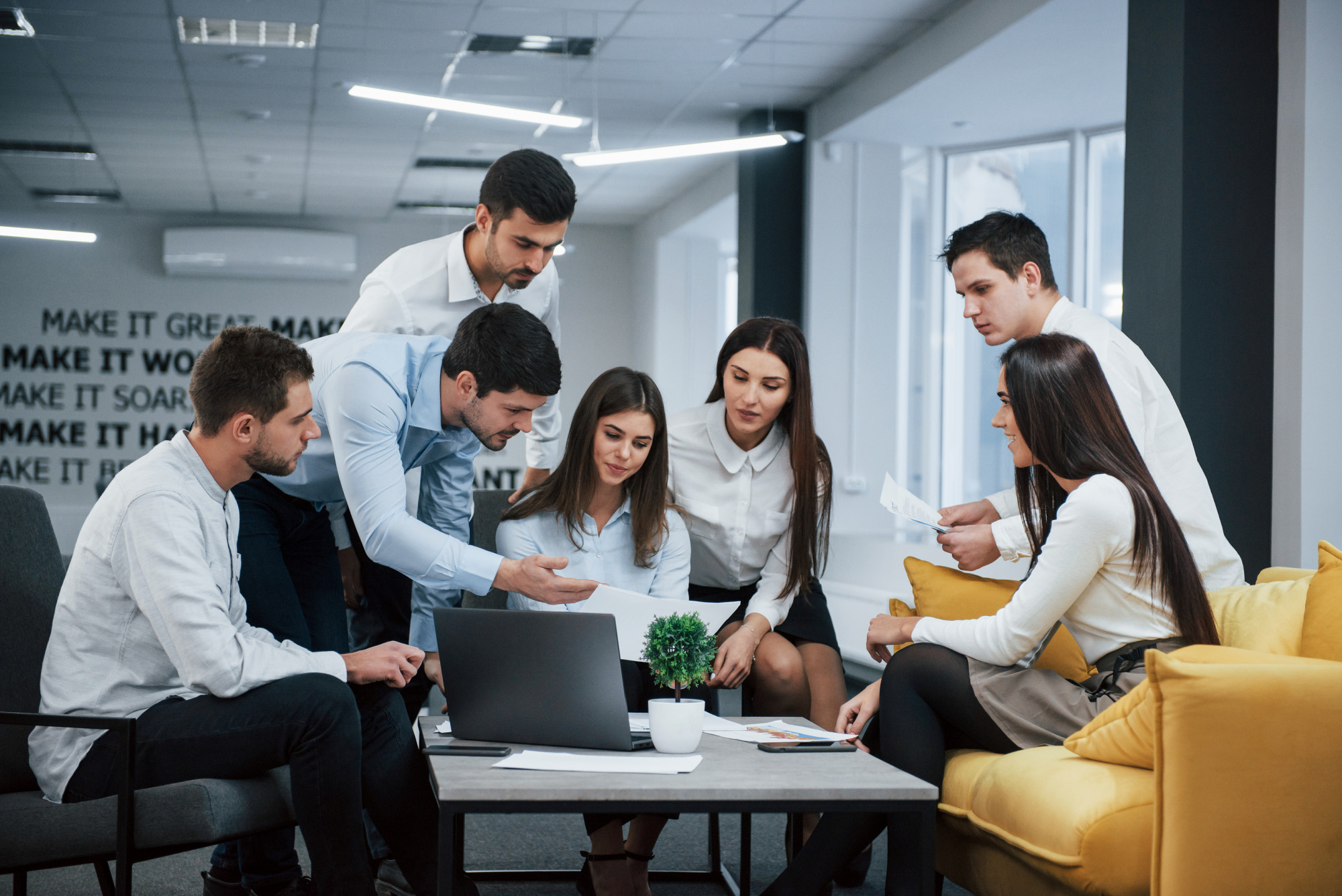 guy-shows-document-girl-group-young-freelancers-office-have-conversation-working